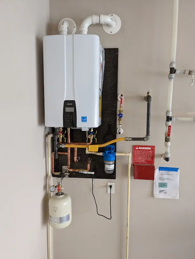 Professional plumber installing copper piping in a Edna home